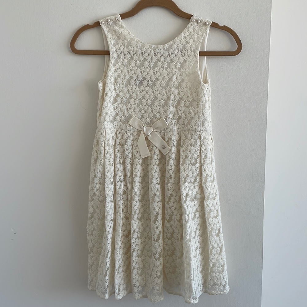 CH Carolina Herrera cream colored, embroidered, pearl buttoned dress for girl.